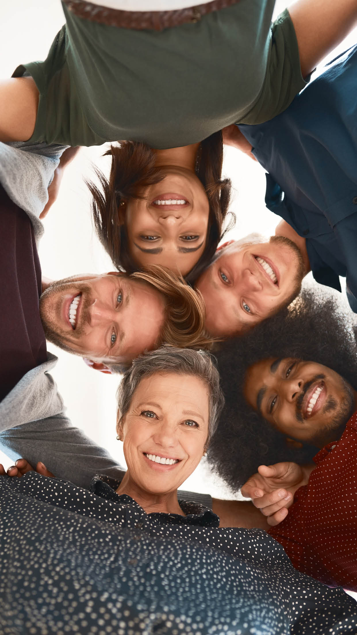 Below, portrait and diversity in office for meeting, business and together for development. Happy, men and woman with teamwork in creative agency or start up company for group, support and growth.
